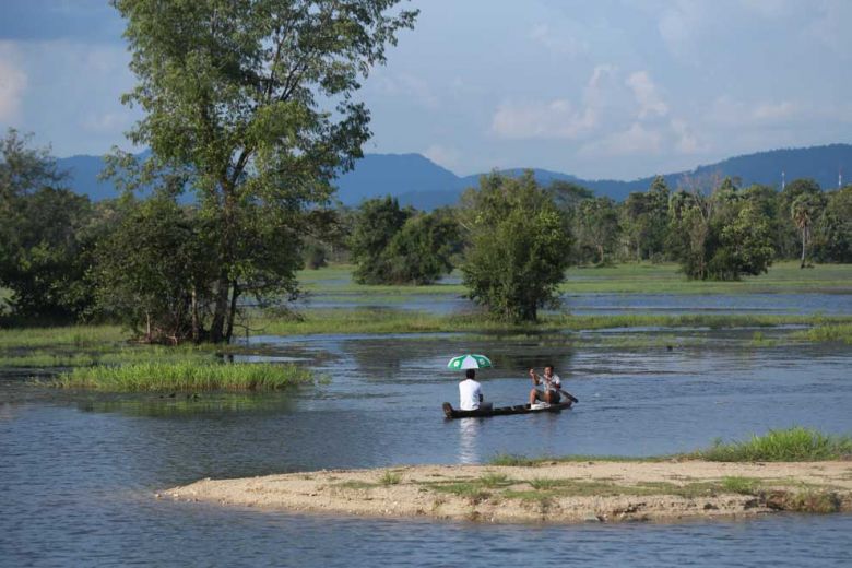 Vat Ven, a fisherman who lives near the dam, takes time to use his fishing boat to row tourists along the channel. Hong Menea