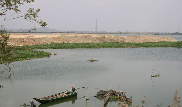 A boat with reclaimed land in the background