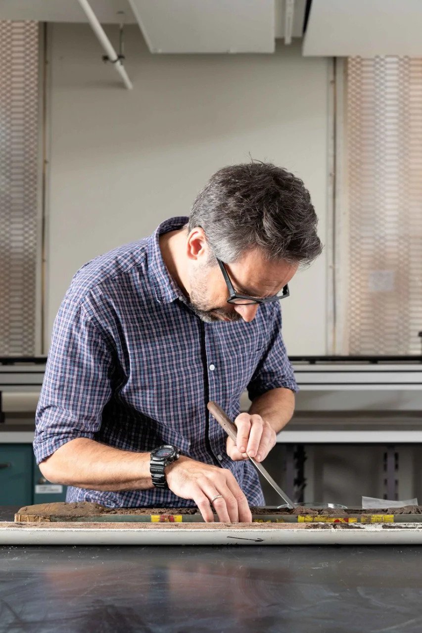 Dr Dan Penny with core samples, in the Geosciences Marine Wet Sediment & Core Analysis Laboratory.