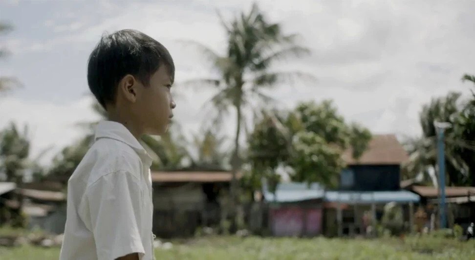 Ngoy as a child (played by an actor) in a still from The Donut King.